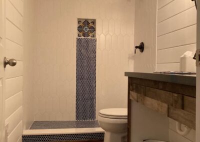 Bathroom Remodel with Floral Tile by Ion Construction Co.